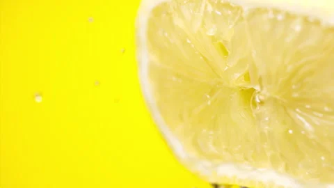 Squeezing out fresh lemon juice at super slow motion at 1000 fps Stock Footage 338063959