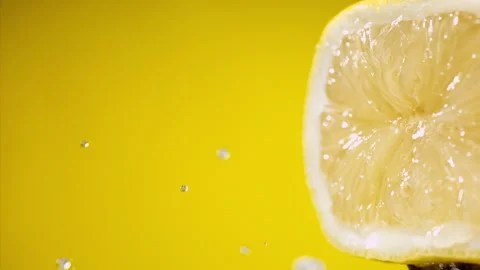 Squeezing out fresh lemon juice at super slow motion at 1000 fps Stock Footage 338064006