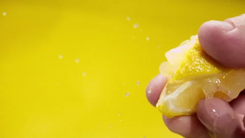 Squeezing out fresh lemon juice at super slow motion at 1000 fps Stock Footage 338064573
