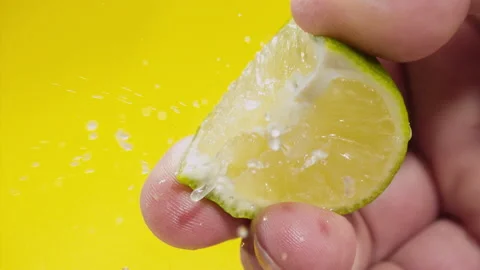 Squeezing out fresh Lime juice drains from the pulp Super slow-mo 1000 fps Stock Footage 163962615