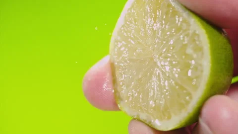 Squeezing out fresh Lime juice drains from the pulp Super slow-mo 1000 fps Stock Footage 276731830