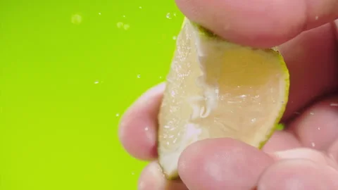 Squeezing out fresh Lime juice drains from the pulp Super slow-mo 1000 fps Stock Footage 281564570