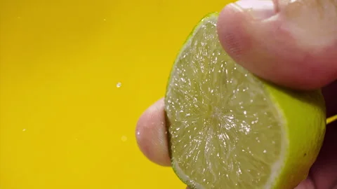 Squeezing out fresh lime juice at super slow motion at 1000 fps Stock Footage 338064685