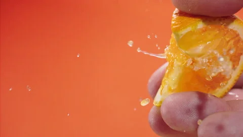Squeezing out fresh orange juice drains from the pulp Super slow-mo 1000 fps Stock Footage 163963288