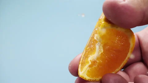 Squeezing out fresh orange juice drains from the pulp Super slow-mo 1000 fps Stock Footage 163963619