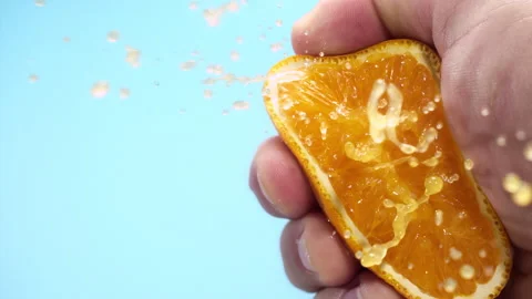 Squeezing out fresh orange juice drains from the pulp Super slow-mo 1000 fps Stock Footage 281564654