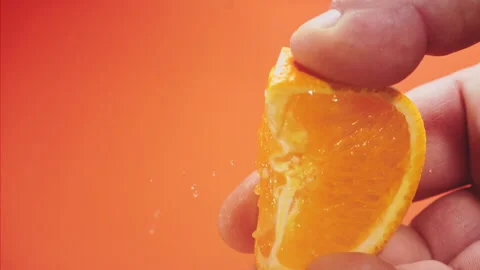 Squeezing out fresh orange juice super slow motion 1000 fps Stock Footage 338064552