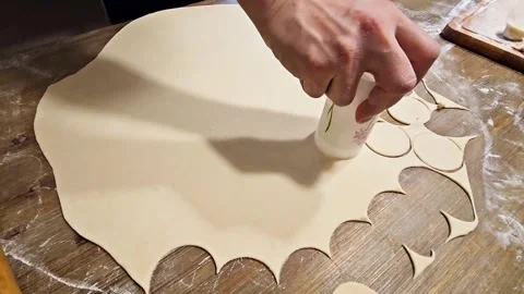 Squeezing out round dough pieces with a glass for making dumplings Stock Footage 309233255
