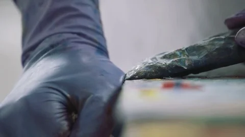 Squeezing Paint out of a Tube Stock Footage 76131472