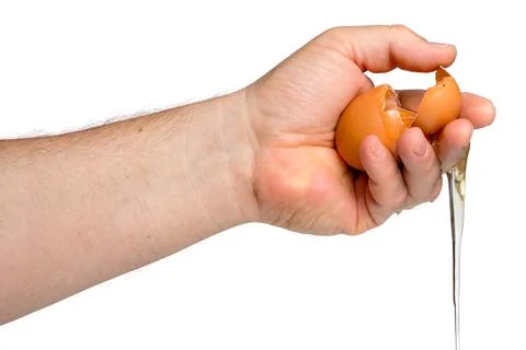 Squeezing Raw Egg with Liquid Drip Photos