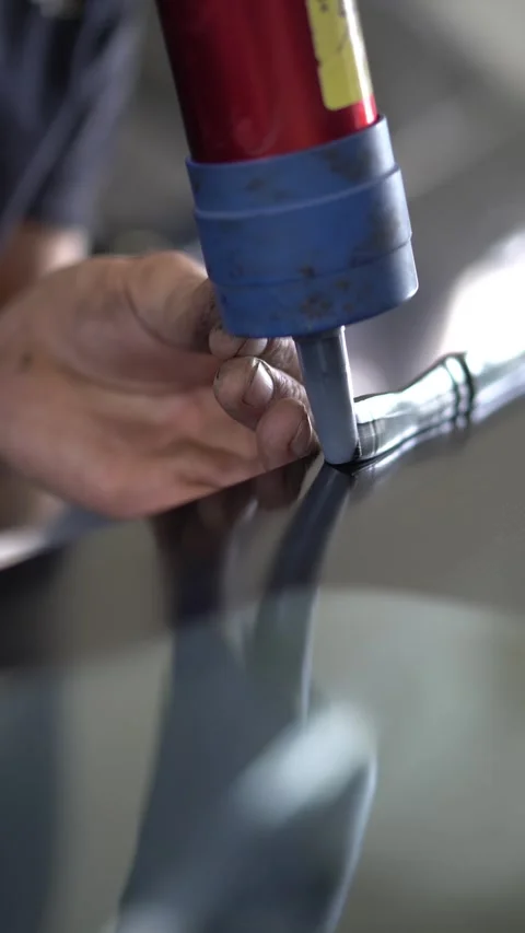 Squeezing sealant glue from a tube using an air gun Stock Footage 314793638