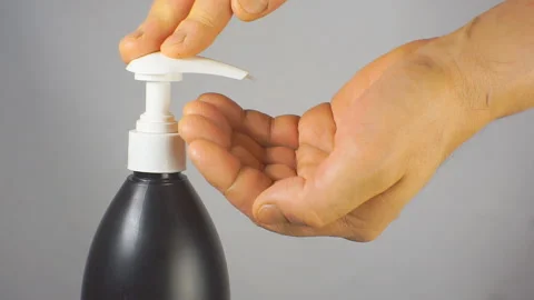 Squeezing the shampoo out of the bottle. Stock Footage 104090475