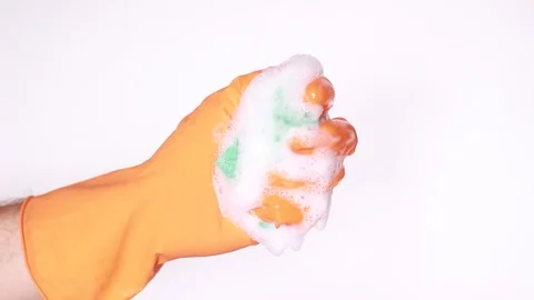 Squeezing sponge in orange glove Stock Footage 97864660