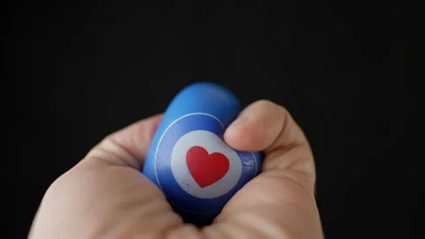 Squeezing A Stress Ball With A Dark Background POV. 4K Vídeos de archivo 273378036