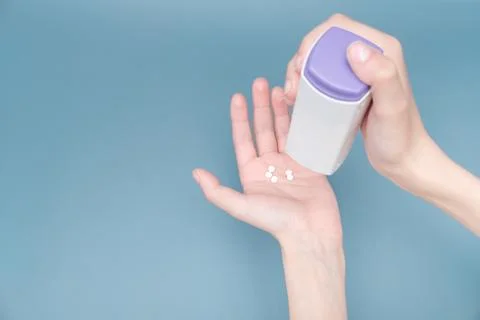 Squeezing a sugar substitute tablet from the package onto your hand Stock Photos