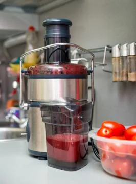 Squeezing tomato juice Stock Photos
