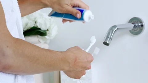 Squeezing toothpaste Stock Footage 129787104
