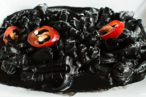 Squid in black marinated sauce Stock Photos