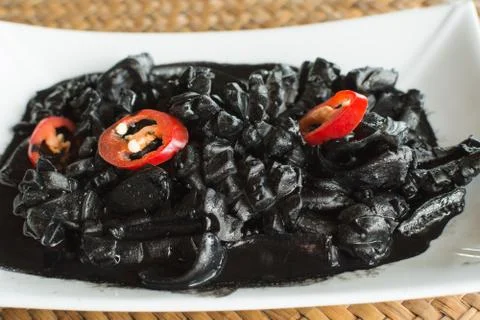 Squid in black marinated sauce Stock Photos
