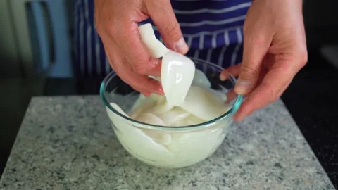 Squid carcasses, a chef mixes with hand the raw calamari in a glass bowl,closeup Stock Footage 135189977