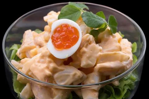 Squid dish with quail eggs, red caviar, and sauce Stock Photos