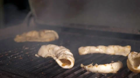 Squid is fried on a large grill Stock Footage 154261846