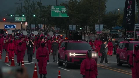 Squid Game costumed parade marching in Seoul Stock Footage 312684303