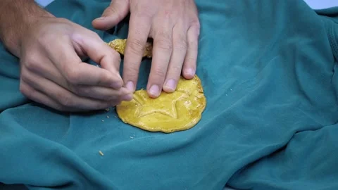 Squid game. Man hands scratch sugar caramel candy in shape of cookies with Stock Footage 163915211
