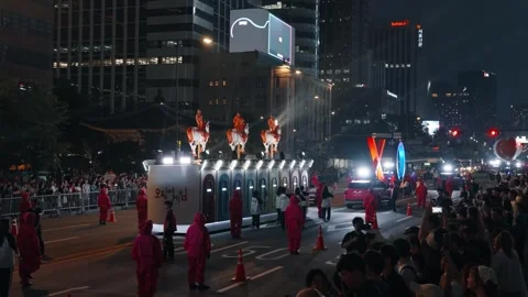 Squid Game parade float with horsemen and costumed participants in Seoul Stock Footage 312684685