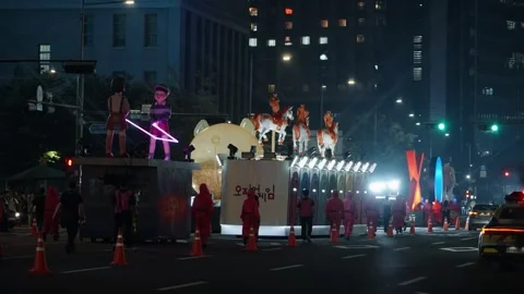 'Squid Game' parade float with the iconic 'Red Light, Green Light' doll in Stock Footage 312319911