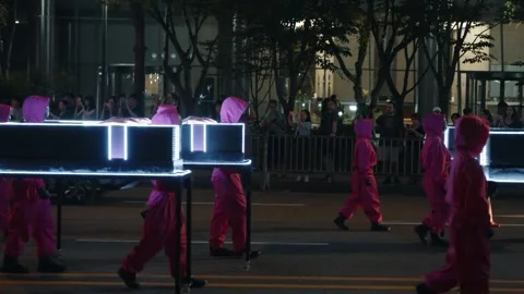 Squid Game Parade Guards Carrying Glowing Coffins in Seoul, South Korea Stock Footage 312741401