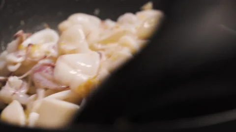 Squid get stir-fried in a pan with garlic and oil. Seafood and asian menu. Stock Footage 147991559