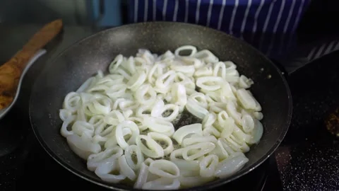 Squid rings are fried in a pan, calamari rings, closeup, 4K Stock Footage 135189964