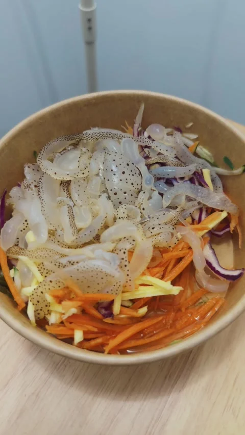 Squid salad with shredded carrots. Red cabbage. Onions. And delicate squid Stock-Footage 340961697
