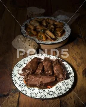 Squid in sauce on porcelain plate on wood Stock Photos