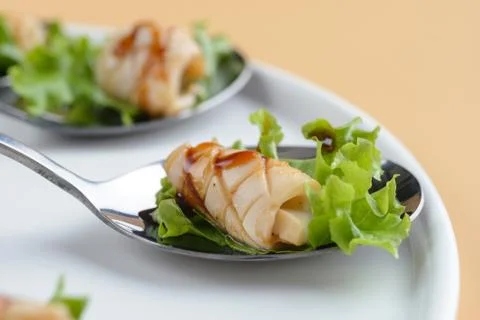 Squid snack on spoon Stock Photos