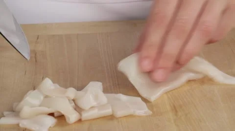 Squid tubes being cut into rings Stock Footage 24666179