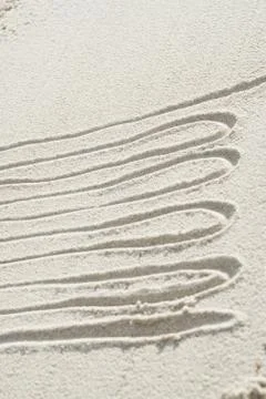 Squiggly pattern drawn in sand Foto stock