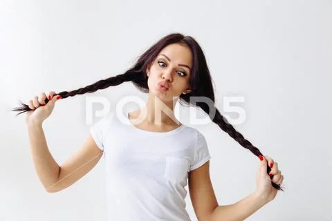 Squint eyed playful beautiful woman showing funny face weird expression isolated Stock Photos