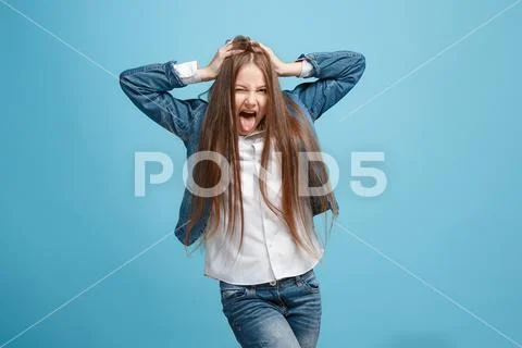 The squint eyed teen girl with weird expression isolated on blue Stock Photos