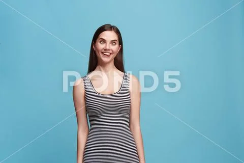 The squint eyed woman with weird expression isolated on blue Stock Photos