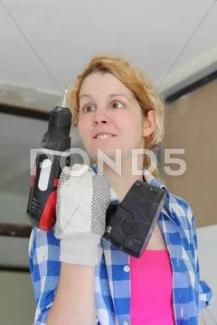 Squint girl with drill Stock Photos