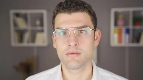 Squint man with glasses looks around. Stock Footage 220170713