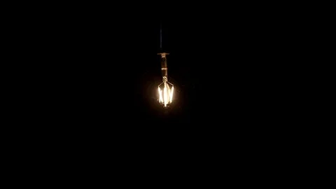 Squirrel cage filament vintage light bulb, retro style glowing round bright Stock Footage 89196029