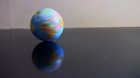 Squishy world that runs on a reflective table Stock Footage 104805115