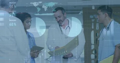 Sr Dr reading and pointing, team tapping tablet checking patient data, charts Stock Photos