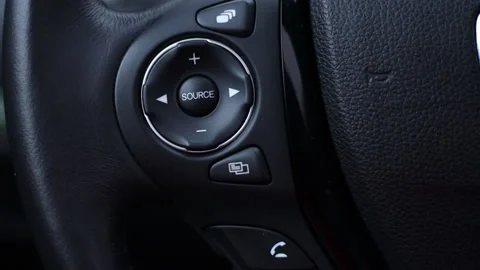 SRC - Source in a modern car on the multifunction steering wheel Stock Footage 164789227