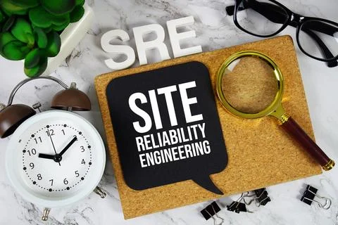 SRE - Site Reliability Engineering acronym with alarm clock and magnifying .. 写真素材
