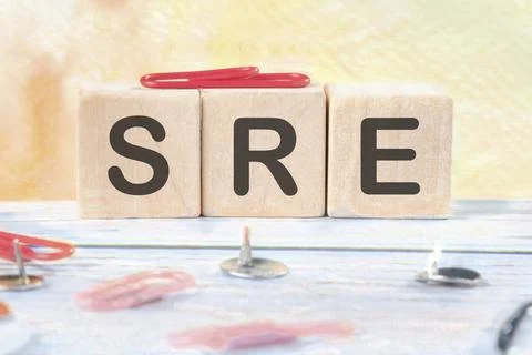 SRE. Site Reliability Engineering signs on wooden cubes on a light background Stock Photos