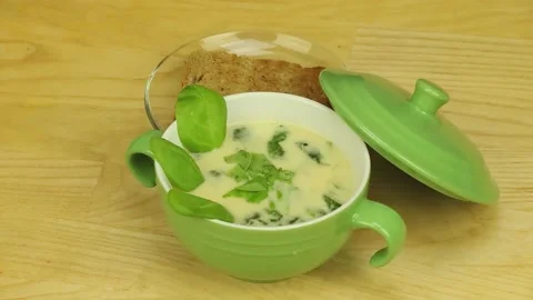 Сream soup with basil and bread Stock Footage 186527483